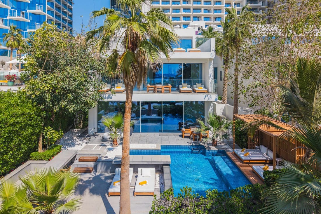 A FIVE Palm beachfront villa and its private pool