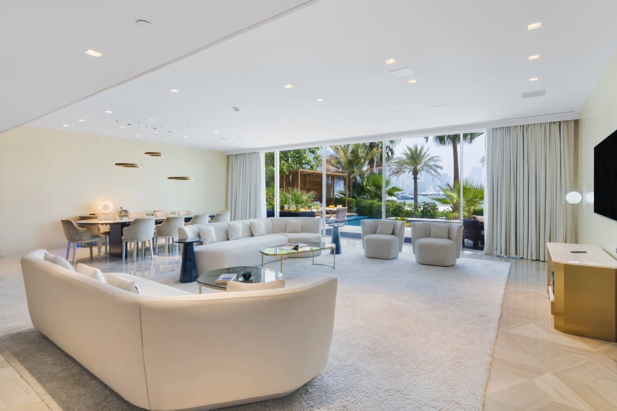 Living room opening onto the pool at a FIVE Palm beachfront villa